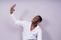 Handsome excited young african business man with mobile phone isolated over gray background Royalty Free Stock Photo