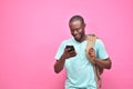 handsome excited young black man feeling excited while viewing content on his smartphone