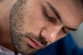 Exhausted man with sweaty face suffering from heat on grey