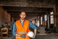 Handsome factory employee after his work indoors