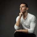 Handsome Fashion Man. Elegant Unsaved Men Face Portrait looking forward in White Shirt over dark Gray Background. Serious Royalty Free Stock Photo