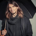 Handsome fashion man portrait wearing black coat. Royalty Free Stock Photo