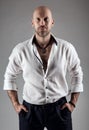 Handsome Fashion Man in White Shirt. Bearded Men Face Portrait over Gray Studio Background. Brutal Bald Head Unshaved Male Model Royalty Free Stock Photo