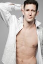 Handsome fashion model posing in white shirt. Royalty Free Stock Photo