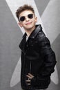 Handsome fashionable little boy in a leather jacket and glasses Royalty Free Stock Photo