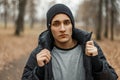 Handsome fashionable man in a black knitted hat with a winter