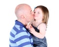 Handsome father kissing toddler daughter on the ch