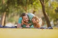 Handsome father piggybacking son playing on nature, daddy holding riding on back adorable cheerful kid boy enjoy active Royalty Free Stock Photo