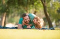 Handsome father piggybacking son playing on nature, daddy holding riding on back adorable cheerful kid boy enjoy active Royalty Free Stock Photo