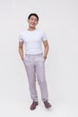 A handsome FIlipino dude in a white shirt and light gray pants. Whole body photo, isolated on a white background Royalty Free Stock Photo