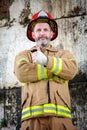 Handsome fireman in uniform with thumbs up