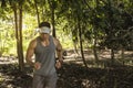 A handsome and fit asian man trail running through a dense tropical forest. Cardiovascular training Royalty Free Stock Photo