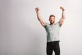 Handsome fit man raising his arms in winning gesture