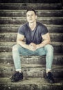 Handsome fit young man sitting on stairs Royalty Free Stock Photo