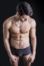 Handsome, fit young man in underwear isolated on black Royalty Free Stock Photo