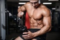 Handsome fitness model holding a shaker in the gym gain muscle Royalty Free Stock Photo