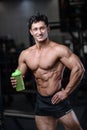 Handsome fitness model holding a shaker in the gym gain muscle Royalty Free Stock Photo