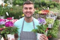 Handsome florist smiling at work