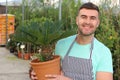 Handsome florist smiling at work