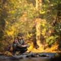 Handsome fly fisherman fly fishing on a splendid mountain river for rainbow trout