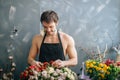 Handsome forist matching flowers and touching them