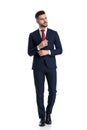 Formal man walking and holding hand on sleeve`s button Royalty Free Stock Photo