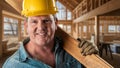 Handsome Friendly Male Contractor at a Construction Site Wearing a Hard Hat and Work Gloves .Holding Wood Lumber