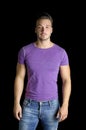 Handsome friendly young man standing in t-shirt and jeans