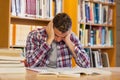 Handsome frustrated student studying his books