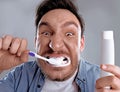 Funny man brushing his teeth