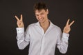 Handsome gay guy smiling in a shirt on a black background Royalty Free Stock Photo