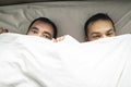 A Handsome gay men couple on bed together under the cover Royalty Free Stock Photo