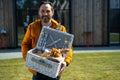 Joyful man carrying basket with delicious food