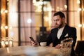 Handsome Gentleman Waiting in Restaurant