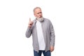 handsome gray-haired elderly man in a shirt is inspired by an idea on a white background with copy space