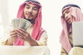 Handsome greedy arab man showing money on hands and counting money. Financial corruption Concept Royalty Free Stock Photo