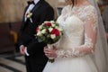 Handsome groom in black suit and stylish bride holding wedding b Royalty Free Stock Photo