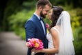 Handsome groom hugging beautiful bride with bouquet in romantic Royalty Free Stock Photo