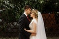 Handsome groom kissing beautiful blonde bride, newlywed couple h Royalty Free Stock Photo