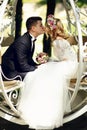 Handsome groom kissing blonde beautiful bride in magical fairy t