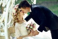 Handsome groom kissing blonde beautiful bride in magical fairy t