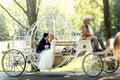 Handsome groom kissing blonde beautiful bride in magical fairy t