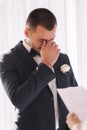 Handsome groom reading wedding vows and started crying. Groom have feeling of overwhelming love for bride Royalty Free Stock Photo