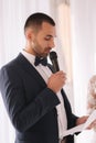 Handsome groom reading wedding vows and started crying. Groom have feeling of overwhelming love for bride Royalty Free Stock Photo