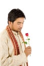 Handsome groom with red rose