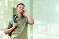 Handsome guy with backpack talking on cell phone Royalty Free Stock Photo