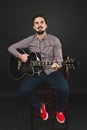 Handsome guy with beard holding acoustic guitar Royalty Free Stock Photo