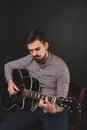 Handsome guy with beard holding acoustic guitar Royalty Free Stock Photo