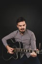 Handsome guy with beard holding acoustic guitar Royalty Free Stock Photo