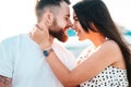 Handsome guy and beautiful girls kissing on the background of a fountain Royalty Free Stock Photo